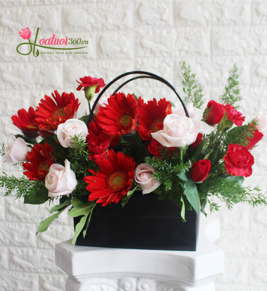 Basket of congratulatory gerbera flowers combined with roses